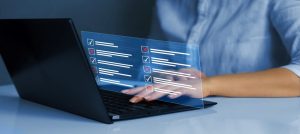 Test Analyst using a laptop to create a digital validation checklist with pass and fail indicators