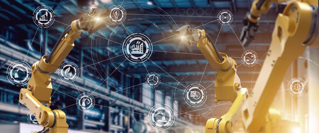 Two robotic arms operate in a high-tech factory with digital icons representing automation, industry, and technology interconnected, symbolising smart manufacturing and industrial automation.