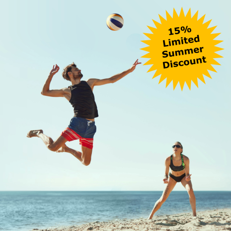 A man jumps to hit a volleyball on a sandy beach while a woman watches. The sea is in the background. A yellow burst graphic reads "15% Limited Summer Discount on professional training courses.