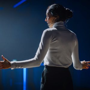 Female speaker delivering a presentation with confidence during a professional communication training session