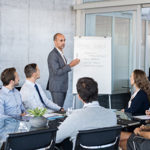 Business leader presenting annual goals to team during a leadership training session in a corporate setting
