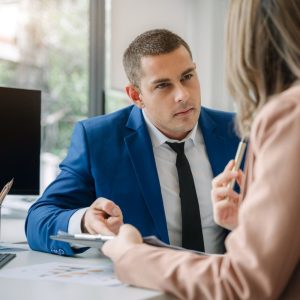 Coach and professional engaged in one-on-one personal development training session at the office